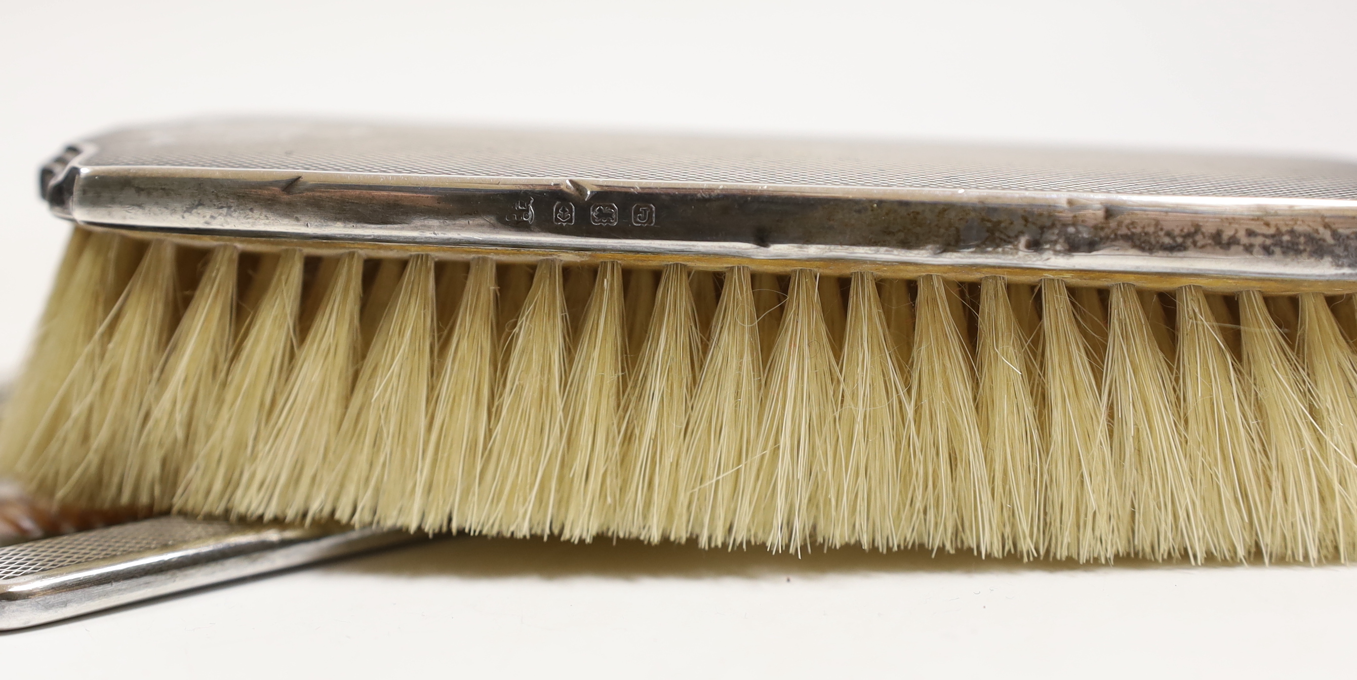 A George V Art Deco silver mounted four piece mirror and brush set, William Neale Ltd, Birmingham, 1933/36.